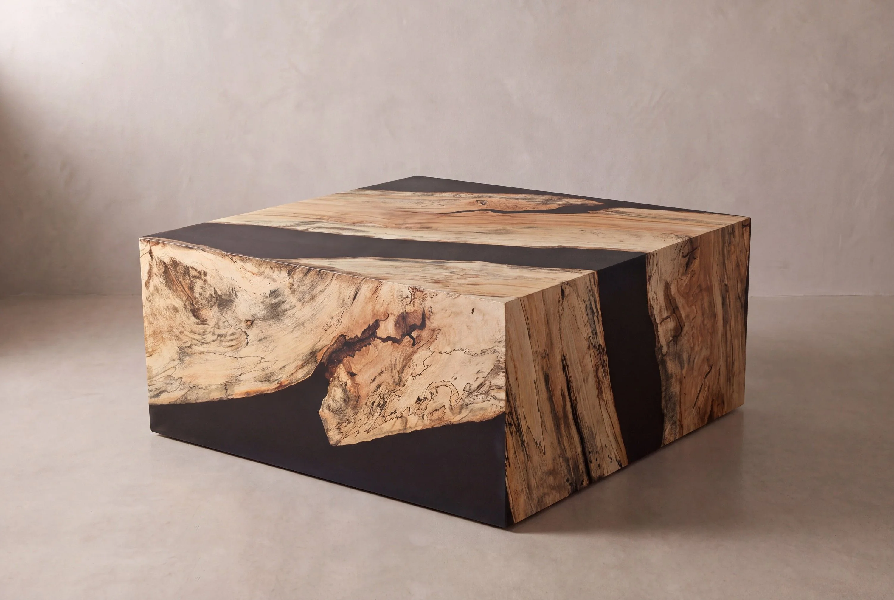 A rendering of a spalted maple waterfall coffee table with a black resin band across the top and down both sides, in a limewash studio.
