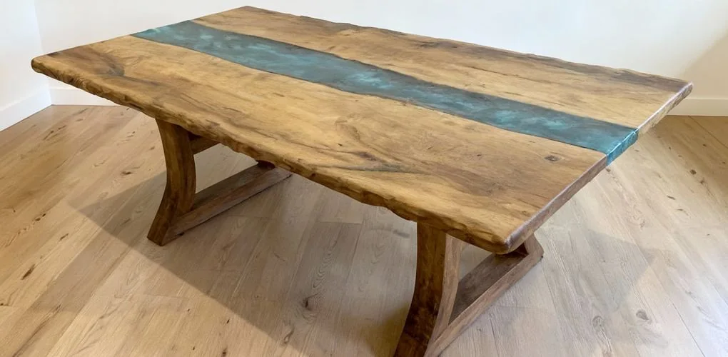Handcrafted walnut and blue resin dining table in elegant minimalist home interior.