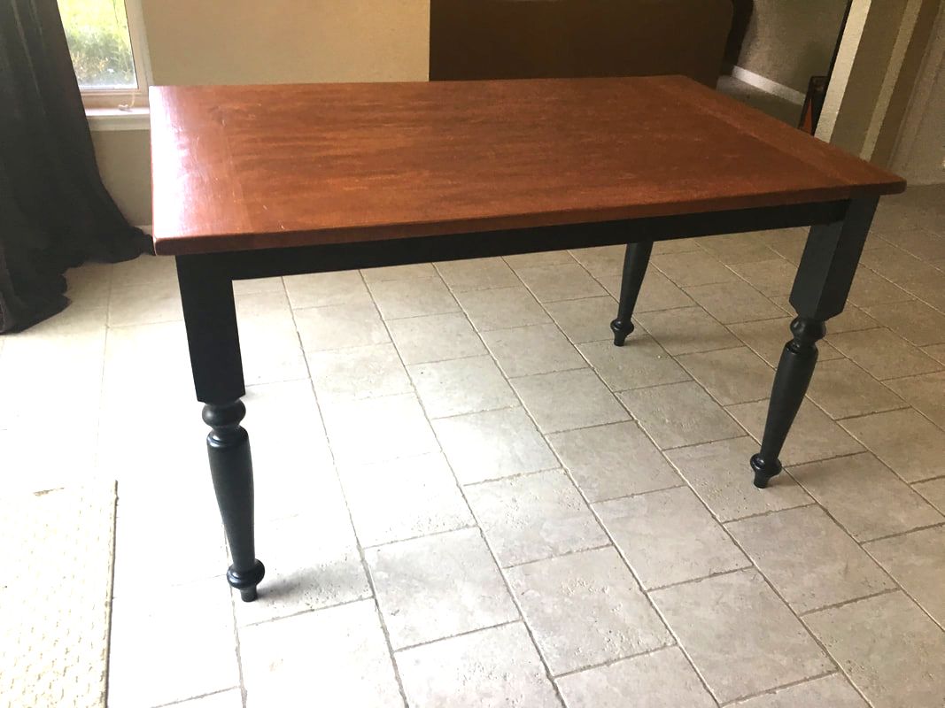 Traditional turned legged farmhouse table with black painted legs and an alder top. 