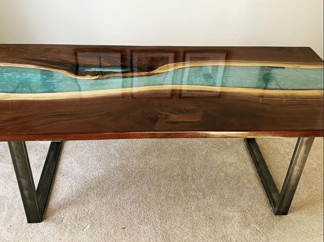 Black walnut steel legged epoxy resin river table with transparent metalic turquoise river made